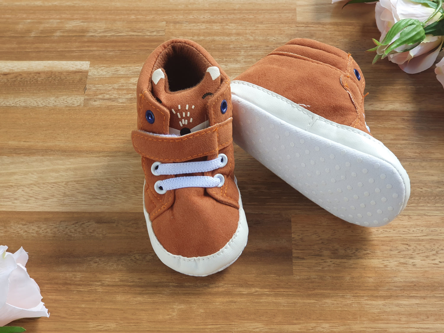 A pair of toddler's brown Fox themed booties with white laces and white soles