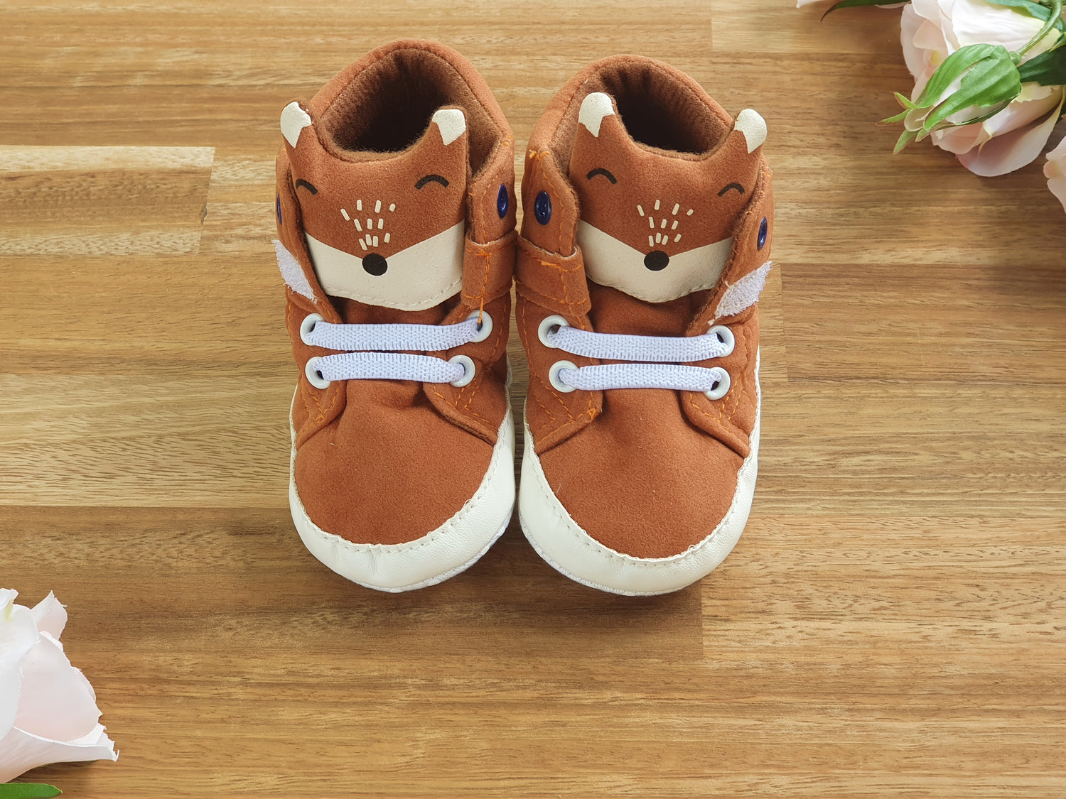 A pair of toddler's brown Fox themed booties with white laces and white soles.
