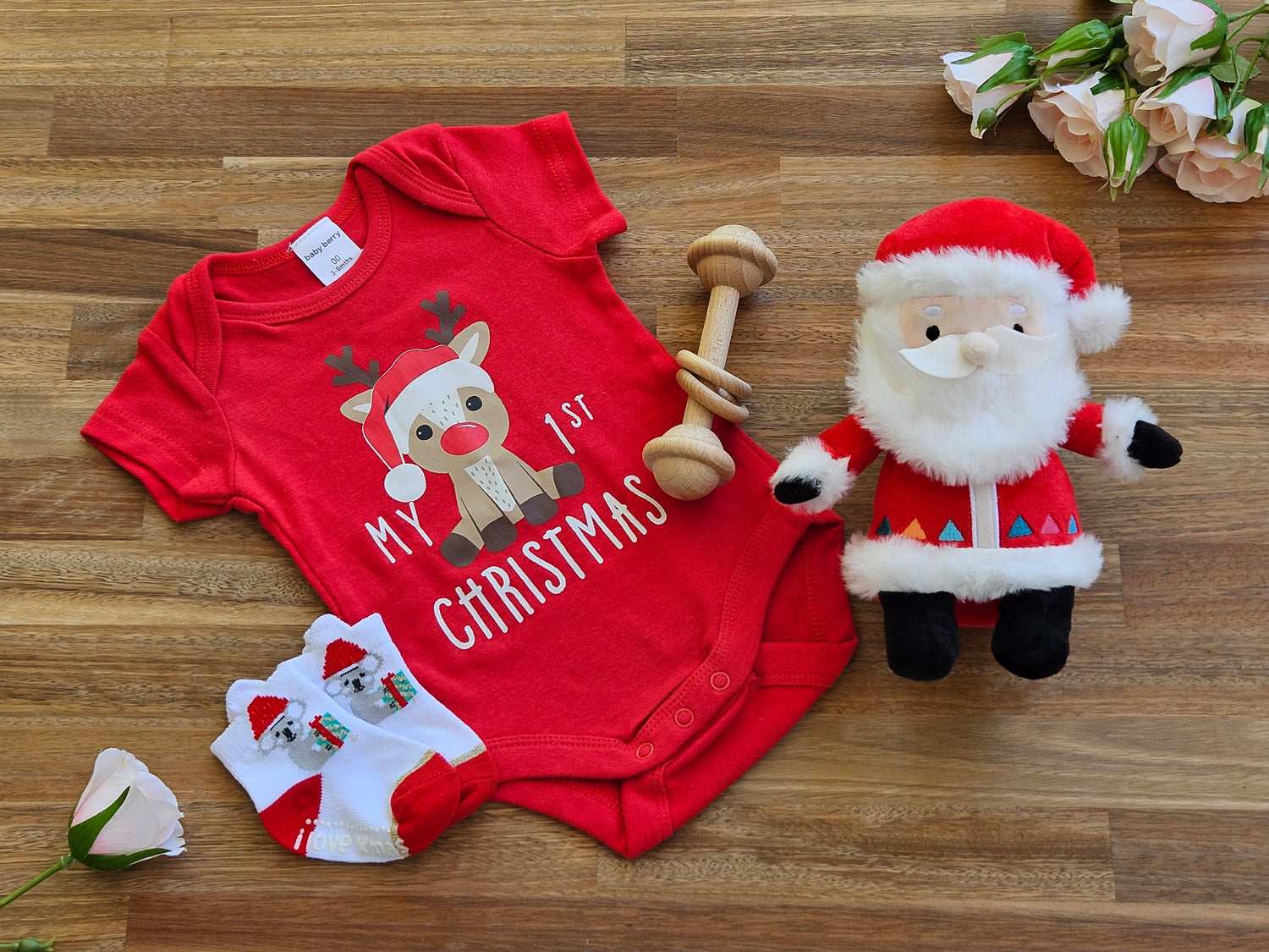 Christmas Gift box includes Red romper with Reindeer print, Christmas socks, Wooden bar toy and a plush Santa