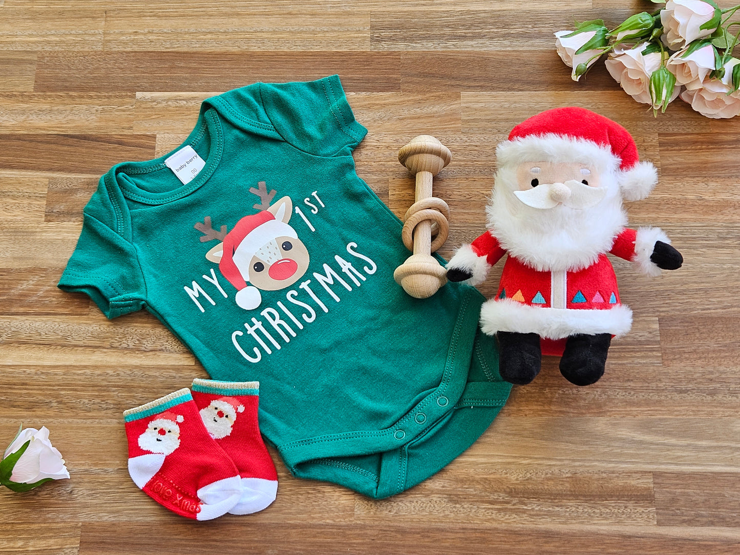 Christmas Gift box includes Green romper with Reindeer print, Reindeer socks, Wooden bar toy and a plush Santa