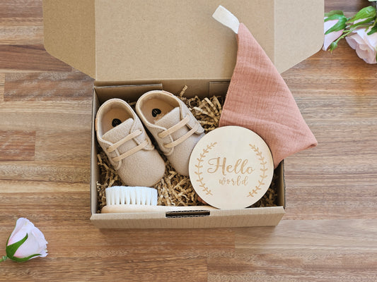 Baby gift box includes, Brown lace up shoe, Muslin burp cloth, wooden hairbrush and a welcome to the world disc