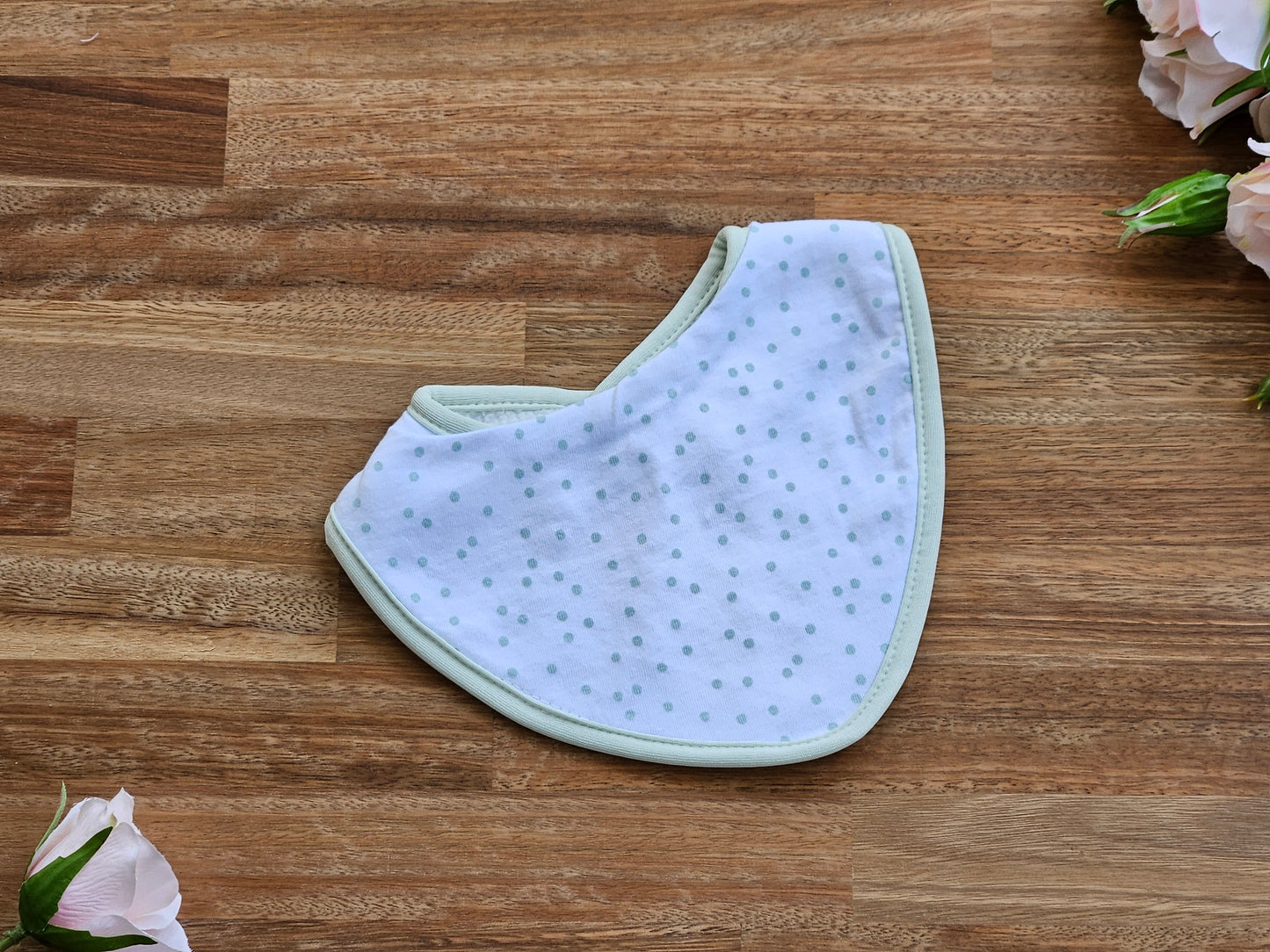wite cotton baby bib with pale green spots