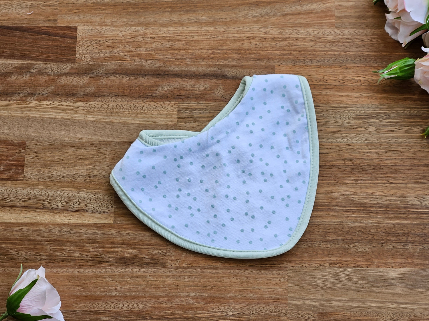 wite cotton baby bib with pale green spots