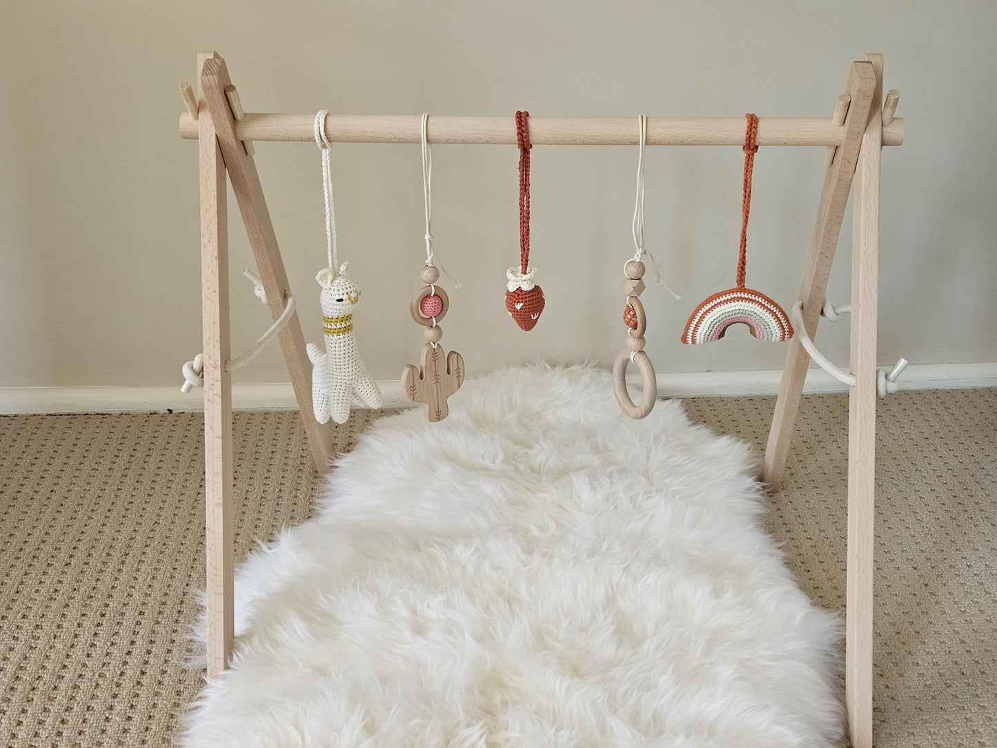 Llama themed wooden baby gym with 5 toys, Crochet beige Llama, crochet strawberry, crochet rainbow, 2 wooden hanging toys.