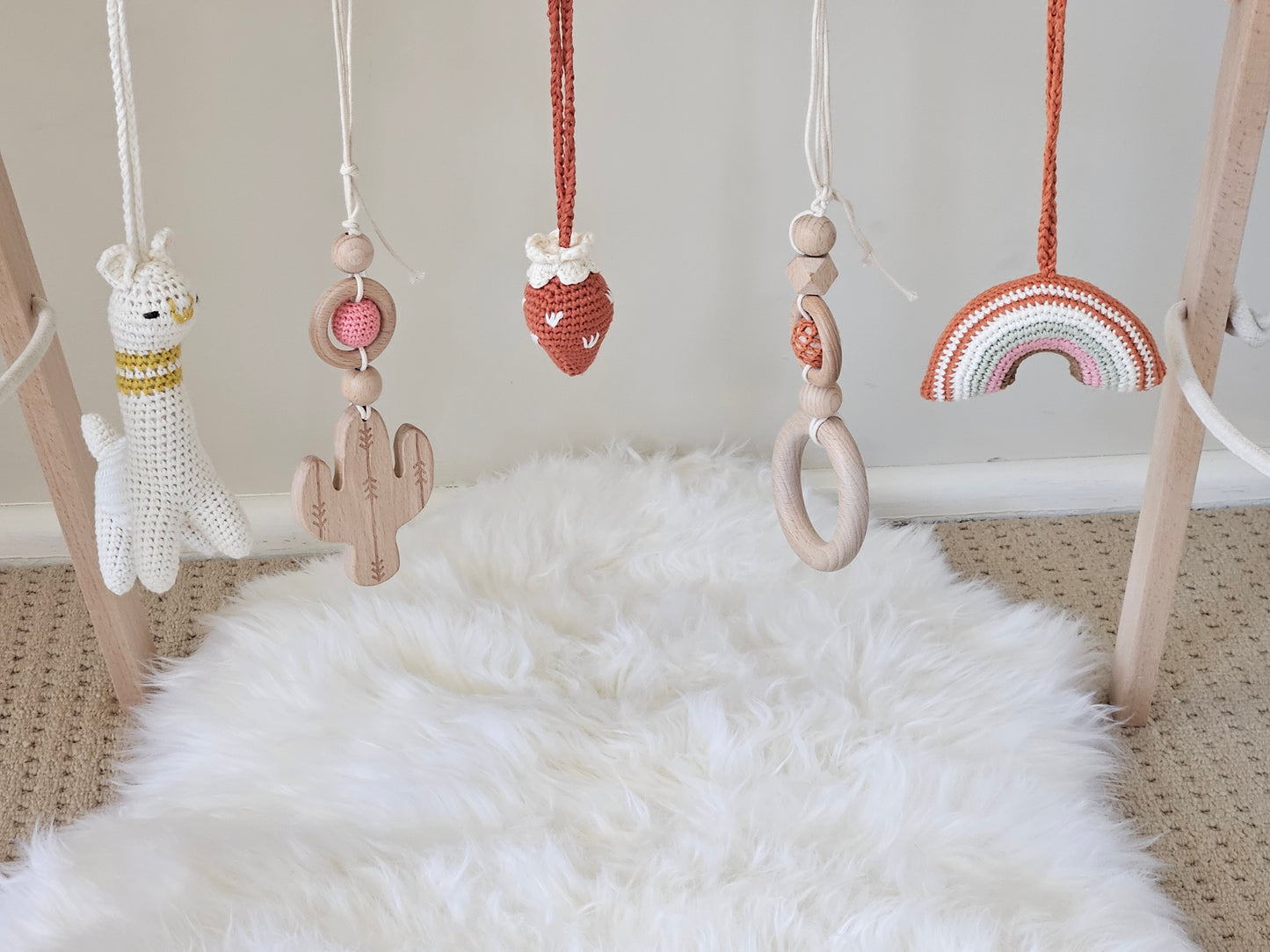 Llama themed wooden baby gym with 5 toys, Crochet beige Llama, crochet strawberry, crochet rainbow, 2 wooden hanging toys.