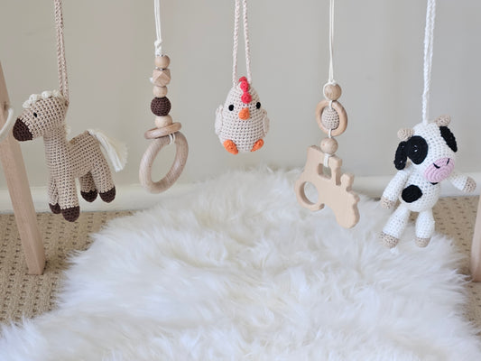 Farmyard themed wooden baby gym with 5 toys, Crochet beige horse, crochet Chicken, crochet Cow and 2 wooden hanging toys ring and tractor.