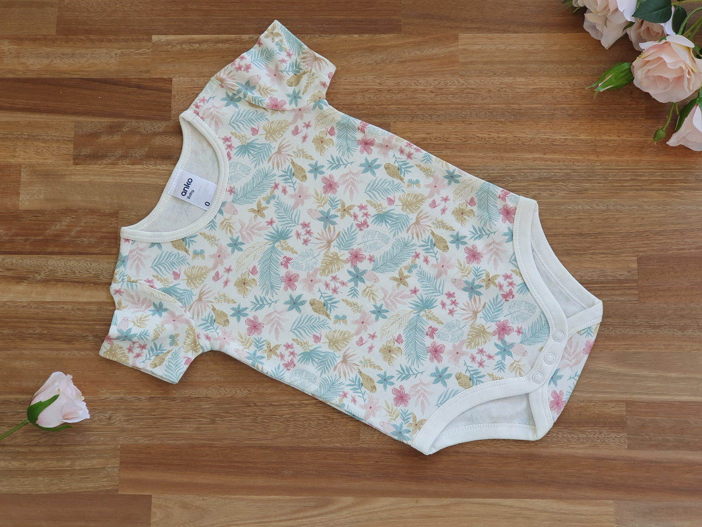 Beige romper with floral pattern